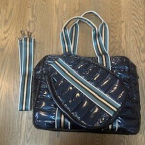 Quilted pickleball bag with handle and crossbody strap.